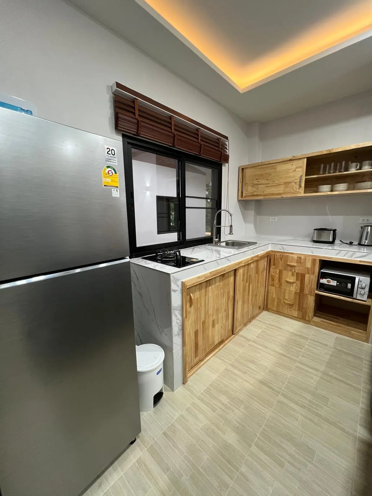 Equipped private villa kitchen with fridge and cooking area